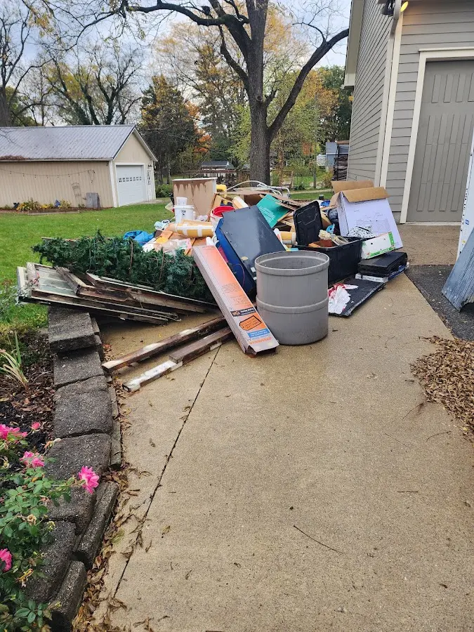 Dumpster being loaded with debris for 10 Yard Dumpster Rental in Marilla